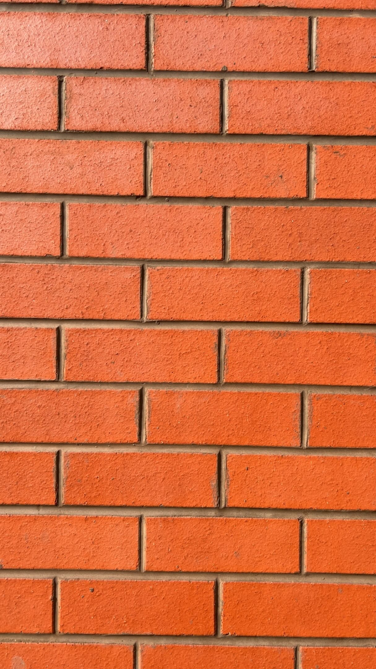 Neatly laid orange facing brickwork with even mortar joints on a DMac Builds project in Wigan
